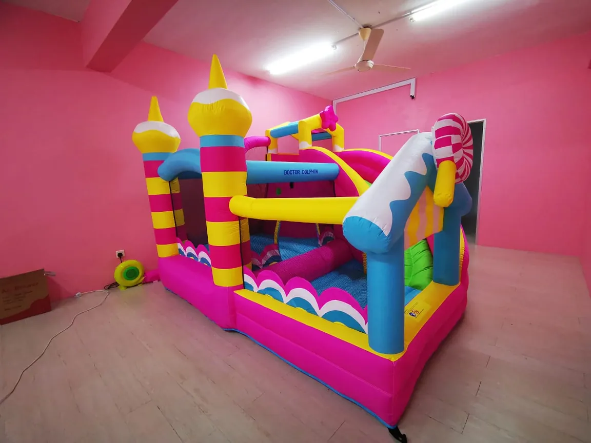 Pink and blue bouncy castle with turrets
