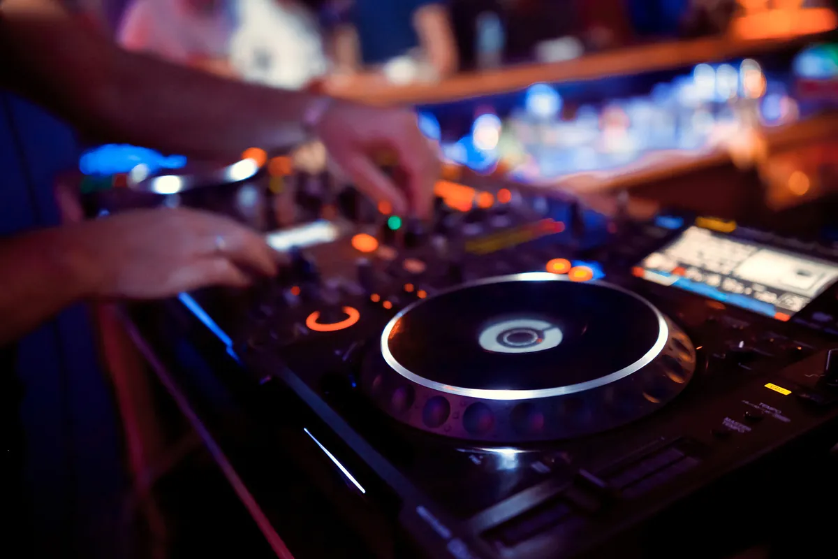 DJ controller and mixer being operated at an event